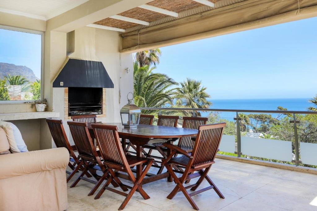 Covered braai terrace with wooden dining table and ocean views