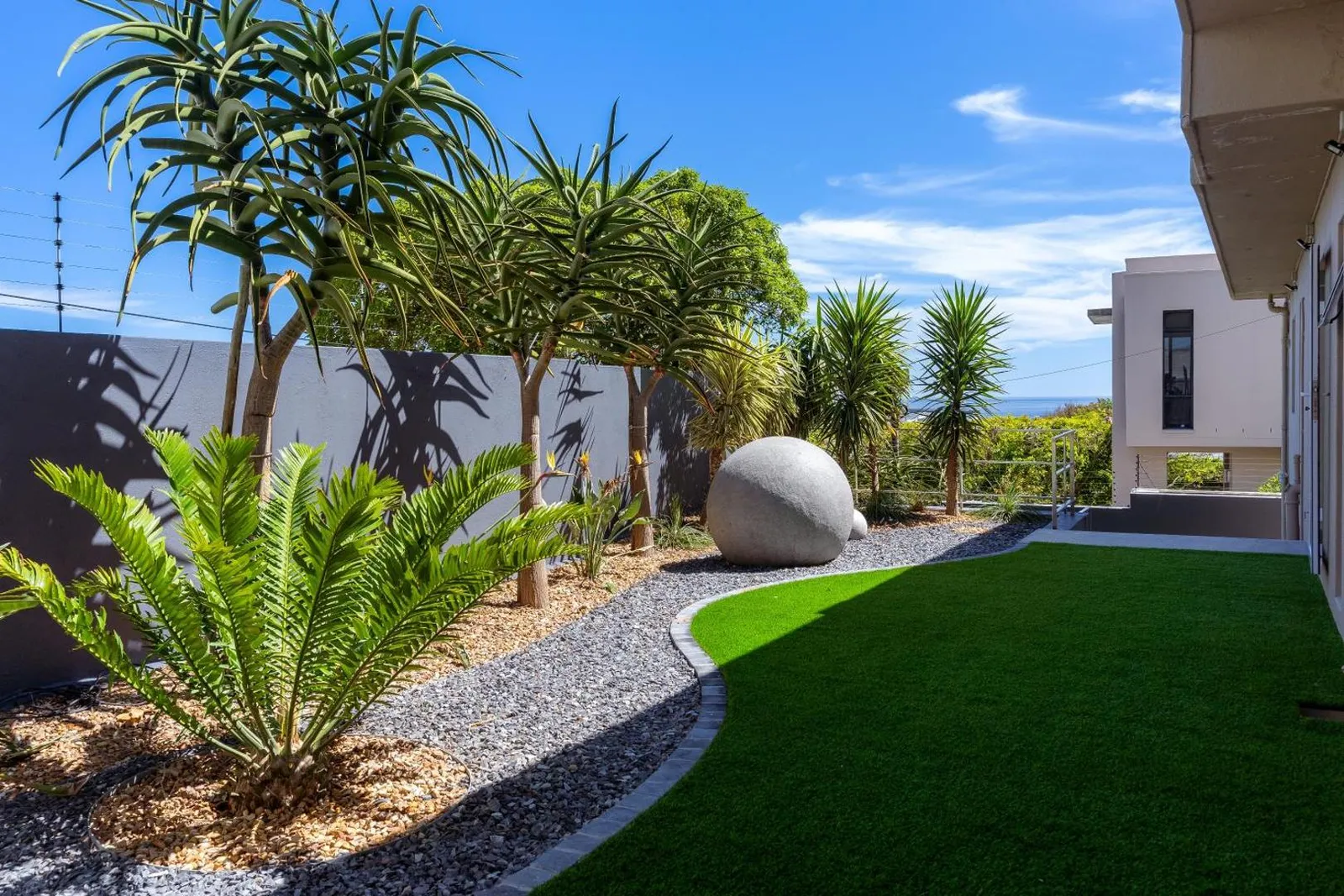 Landscaped lawn and succulent garden beside the villa