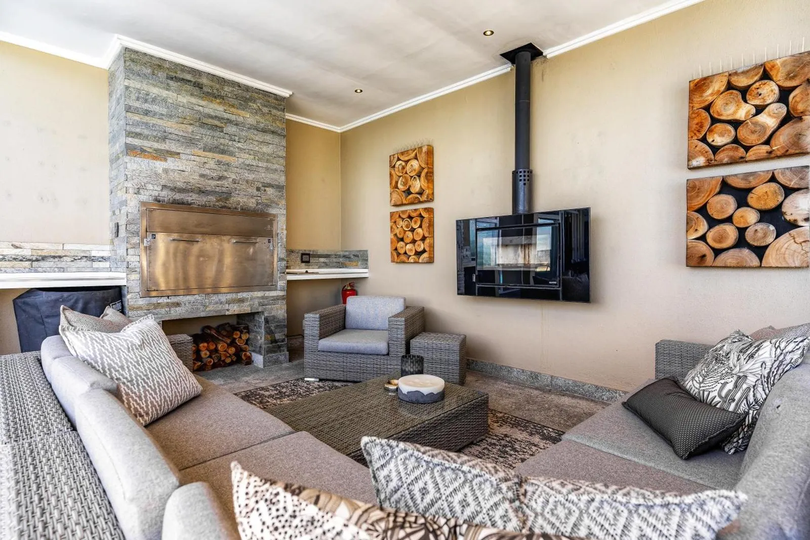 Lounge with a stone fireplace and wood burner