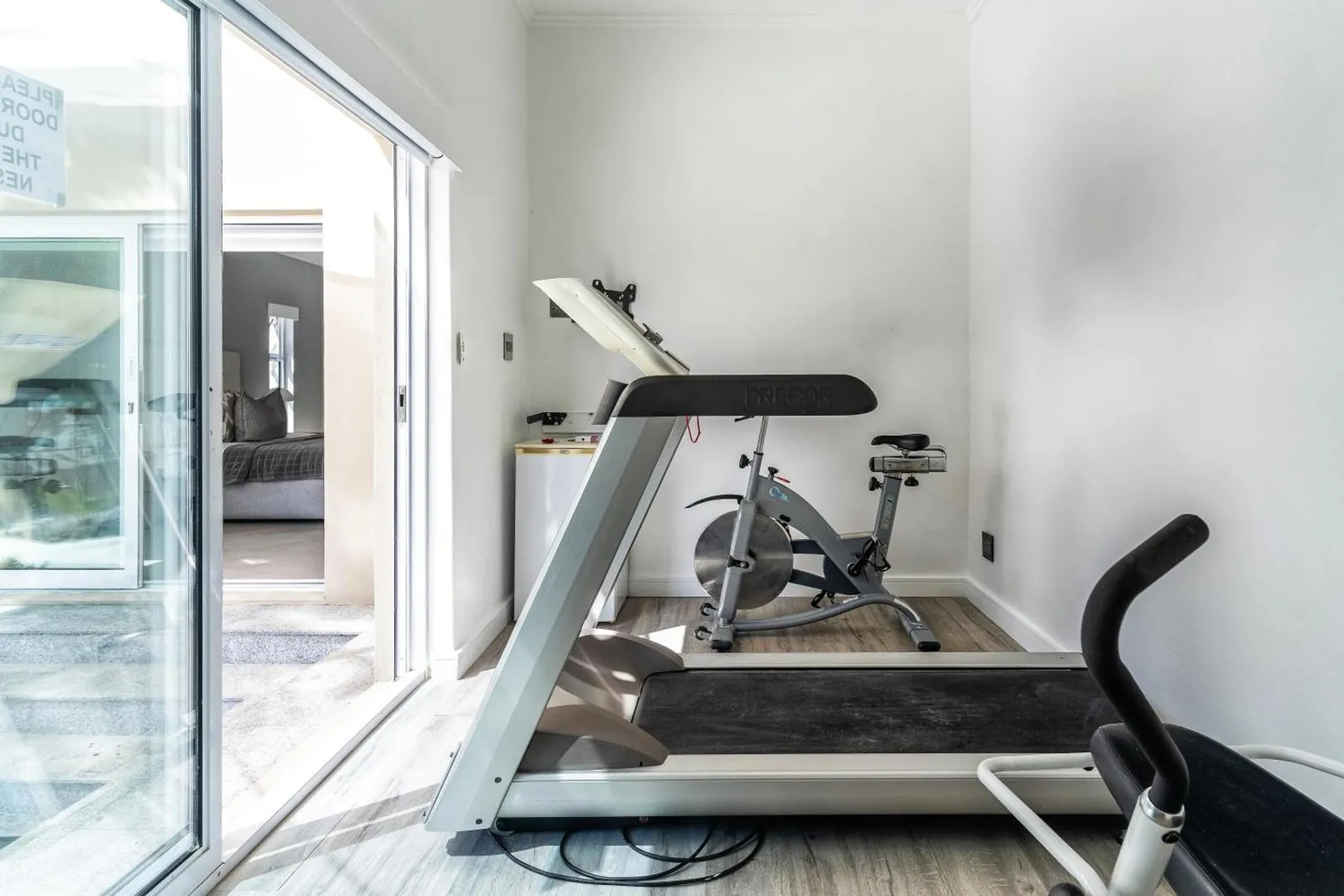 Home gym with a treadmill and exercise bike