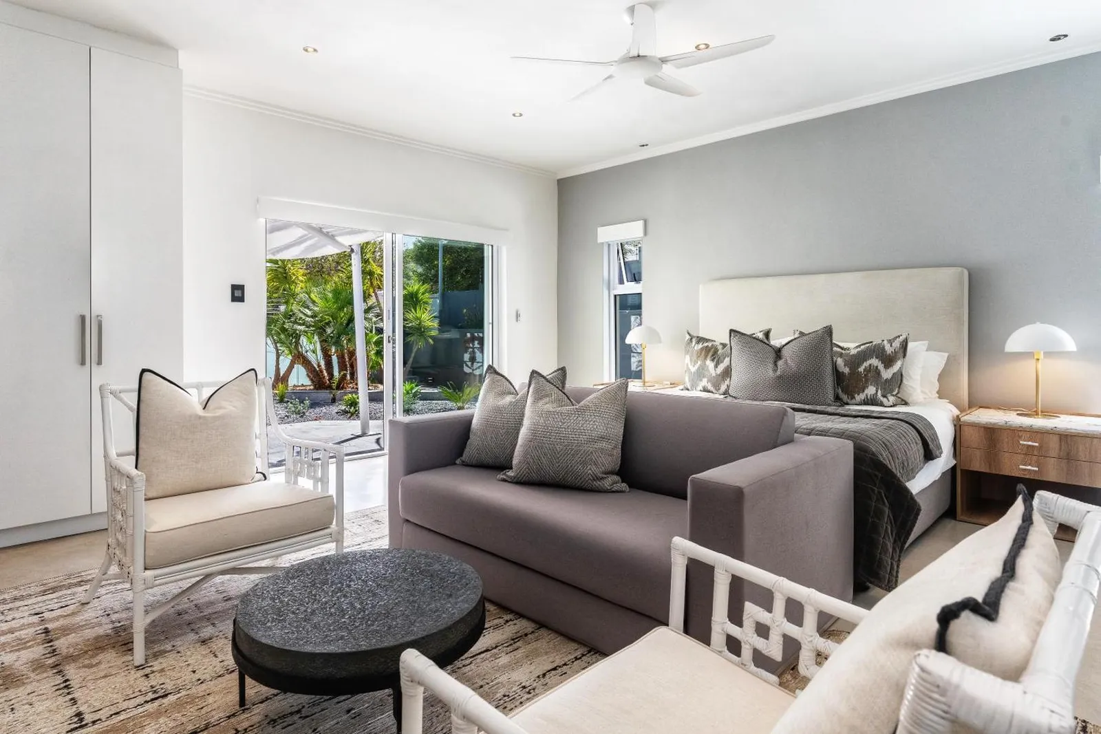 Bedroom with a sofa and doors onto the garden