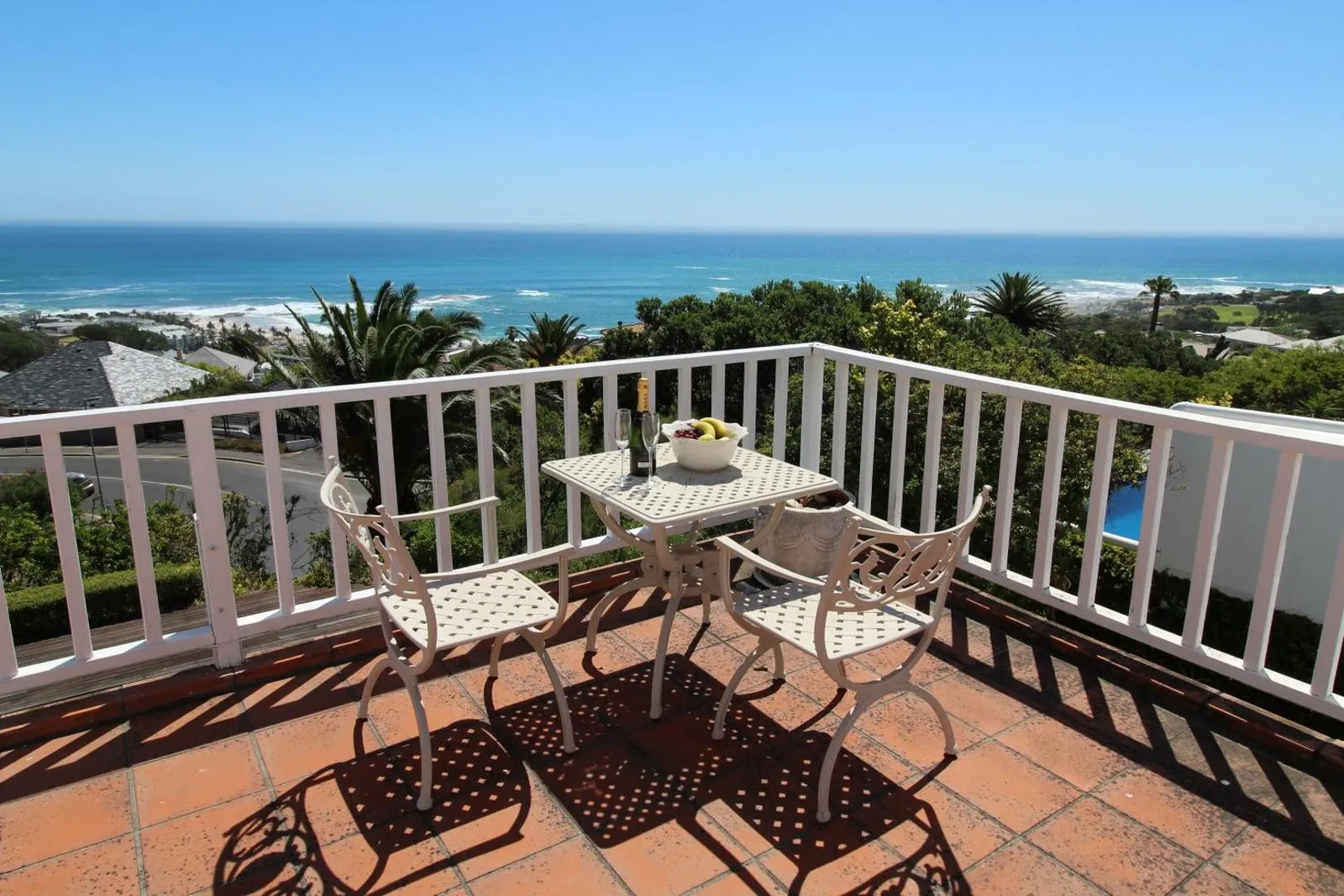 Balcony table set above the bay and the beachfront