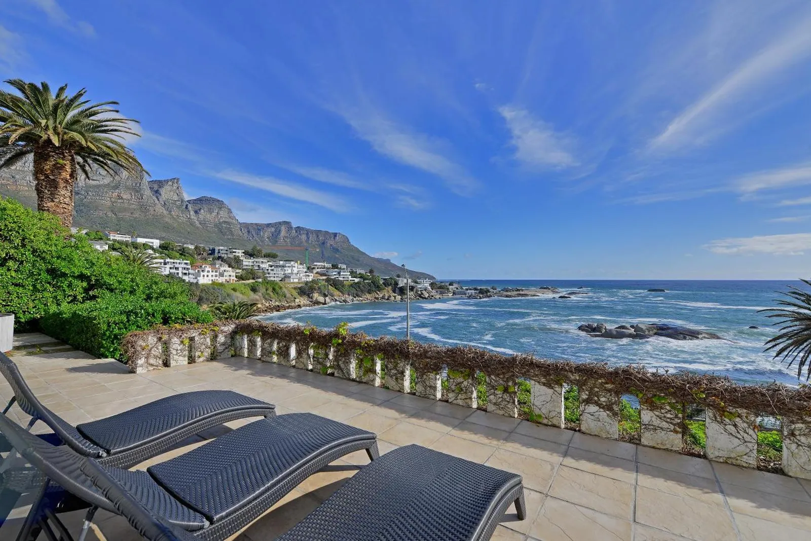 Sun loungers on the terrace high above the bay