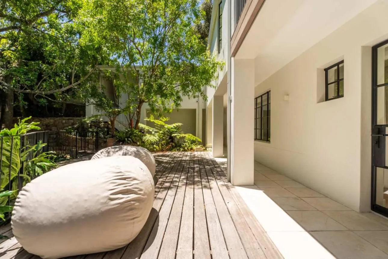 Shaded deck with a beanbag under the canopy of trees