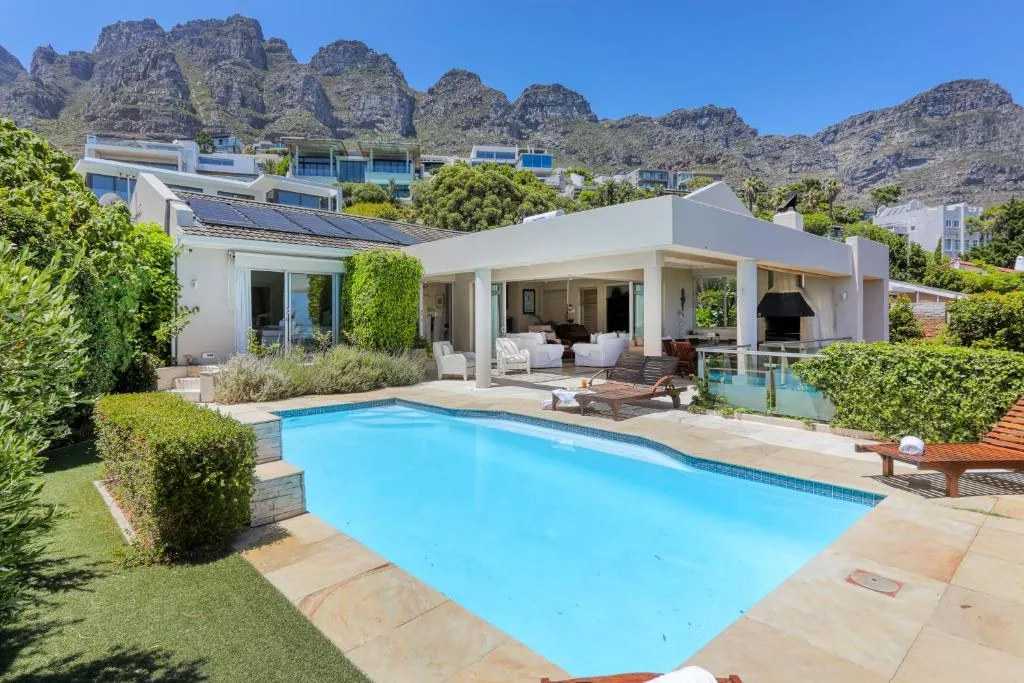 Pool and terraced villa beneath the Twelve Apostles mountain range