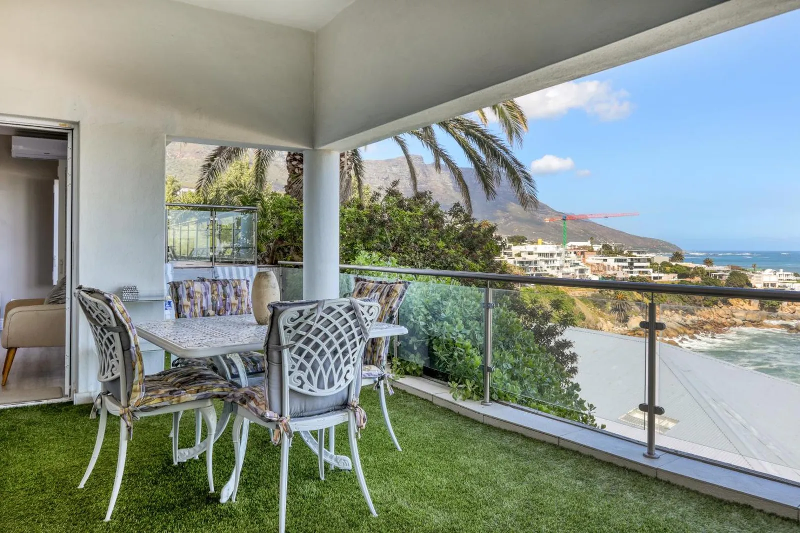 Covered balcony dining above the beach with Lion's Head beyond
