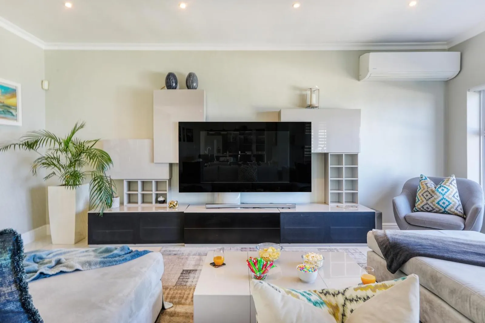 Lounge with a corner sofa and wall-mounted television