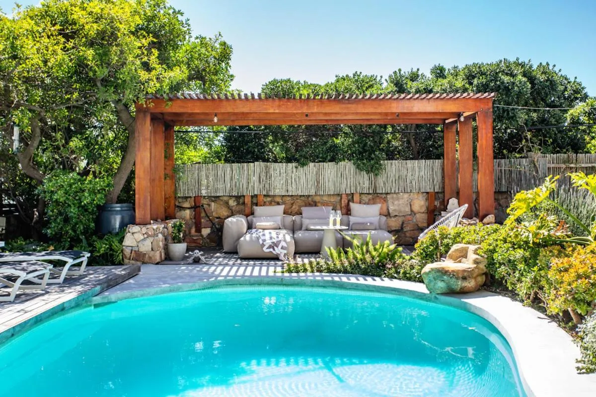 Pool with a pergola lounge in the walled garden