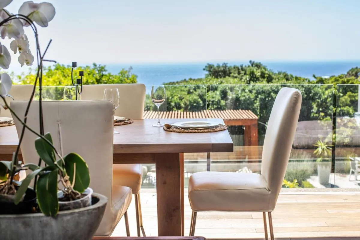 Outdoor dining table on the deck with the sea beyond