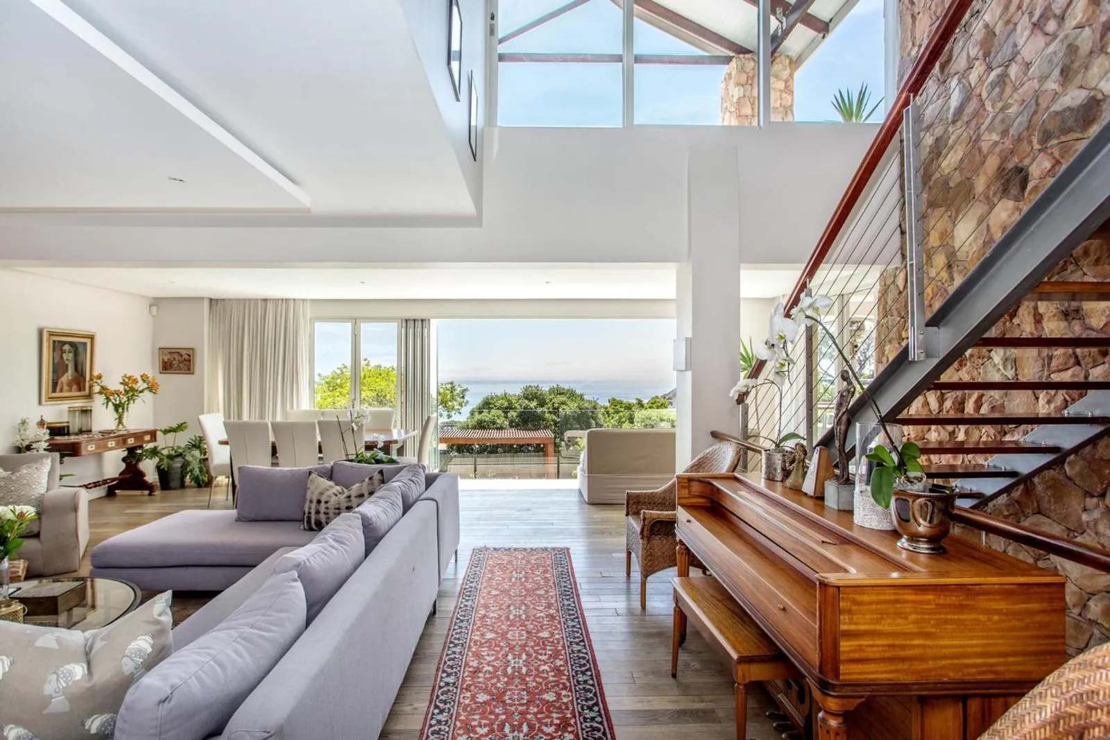 Living room with an open staircase and sea views