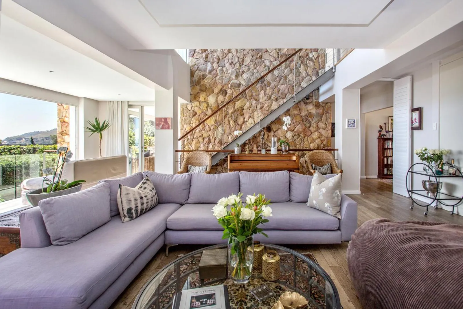Lounge beside the stone feature wall and staircase
