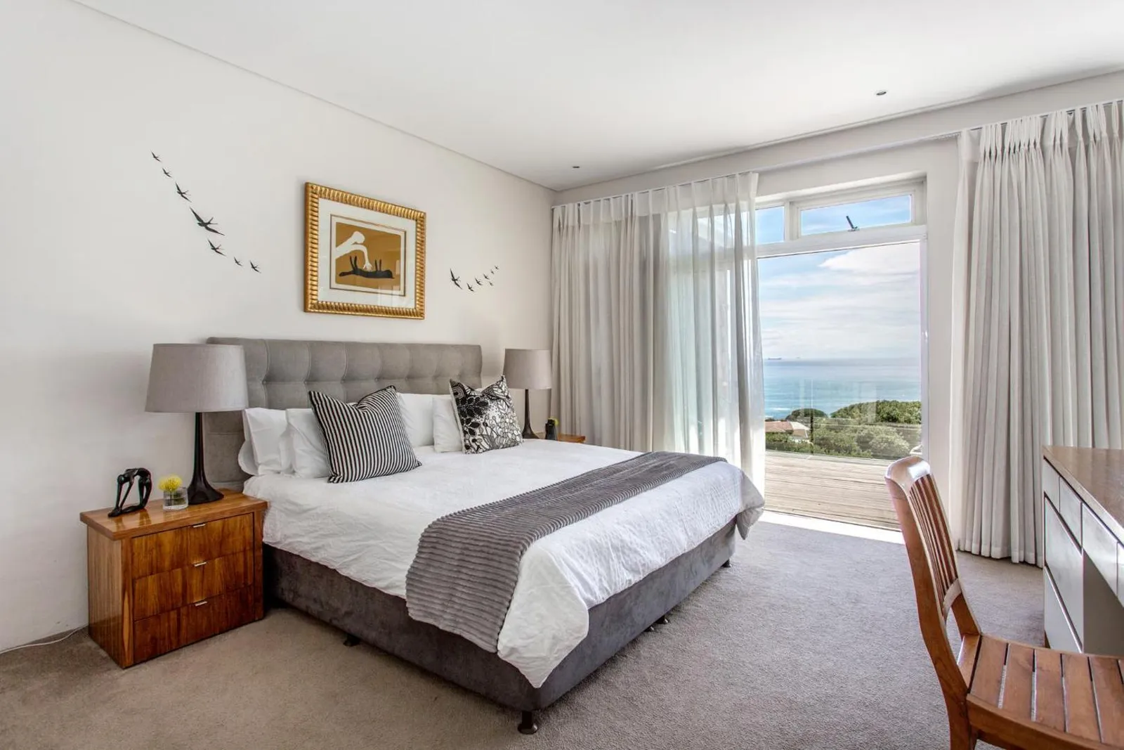 Bedroom with deck access and the ocean beyond