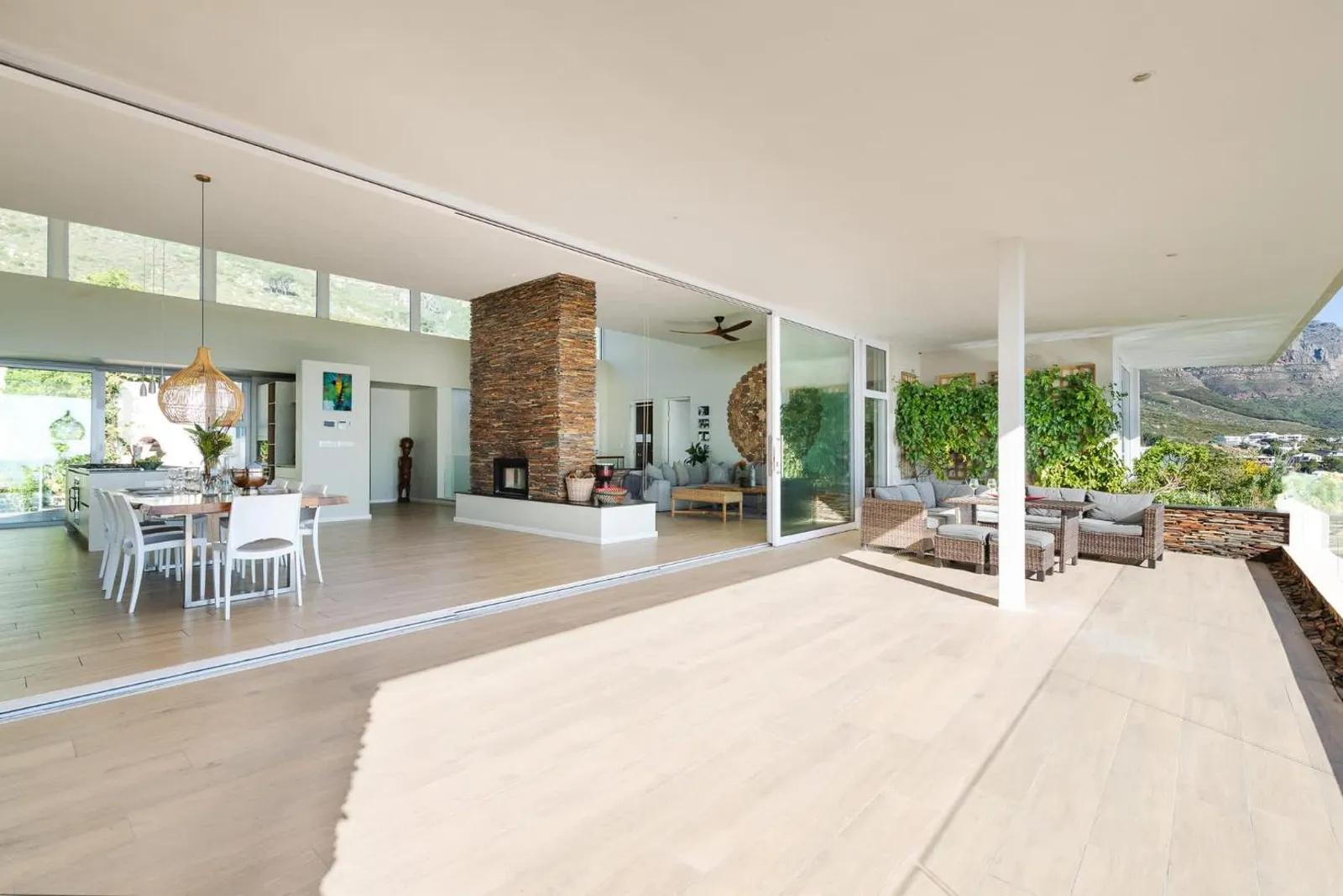 Open-plan living room with a stone fireplace