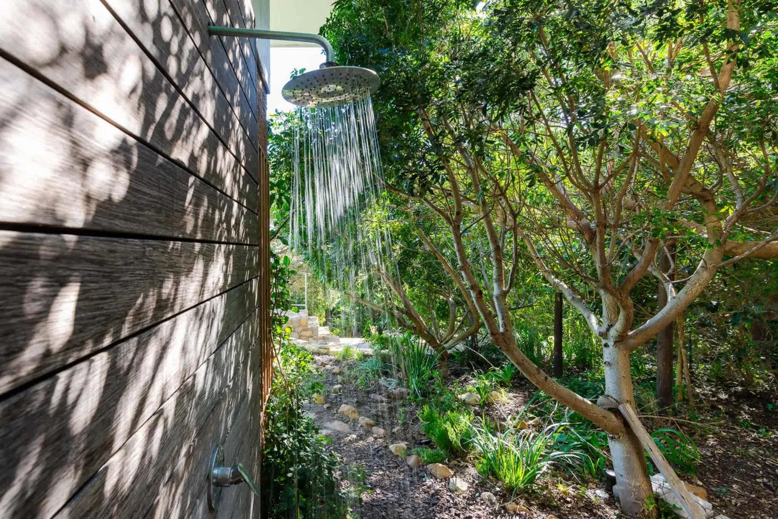Outdoor shower set into the garden wall