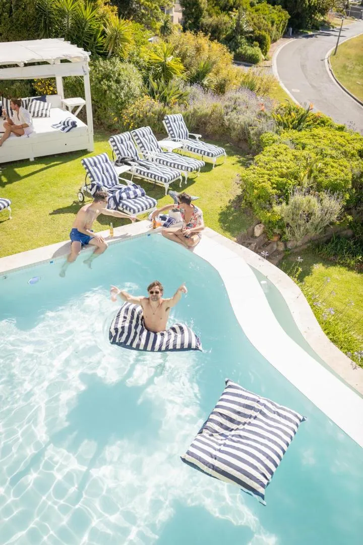 Pool and sun loungers on the lawn in full sun
