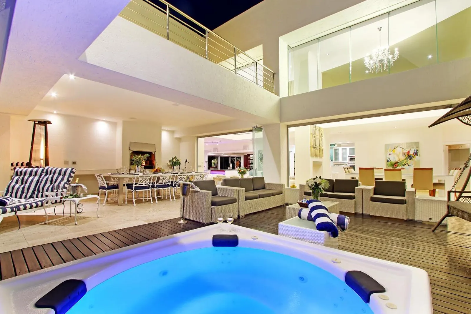 Spa jacuzzi and lounge deck lit at night