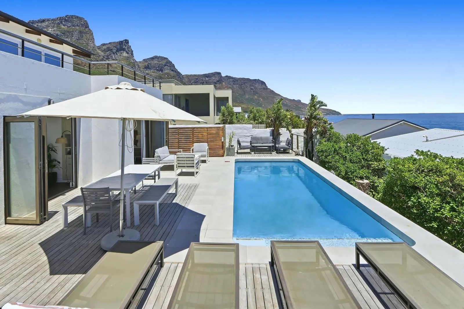 Pool deck beneath the Twelve Apostles with the sea beyond