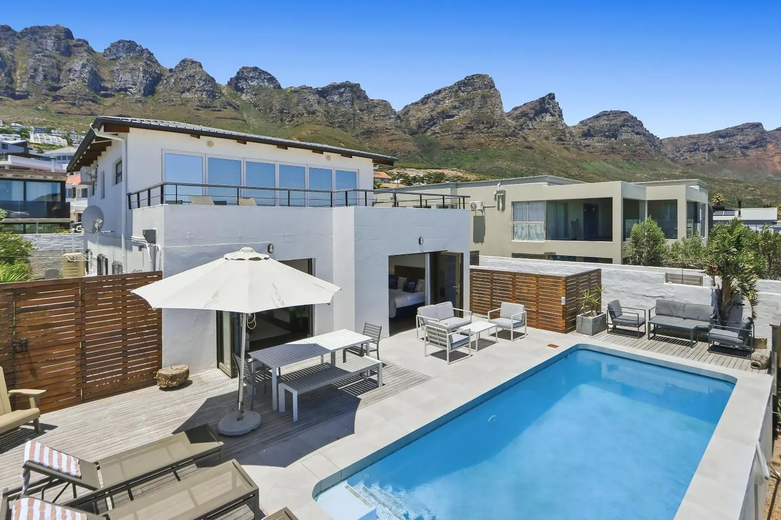 Villa and pool with the mountain range rising behind
