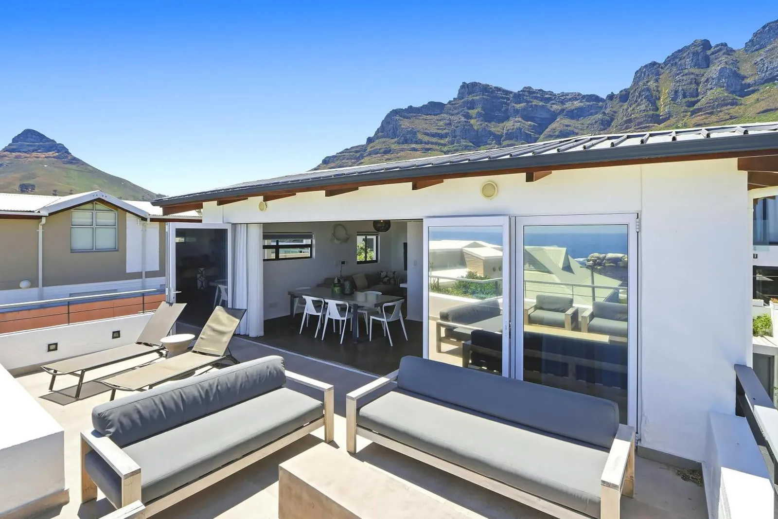 Covered terrace loungers with the mountains behind