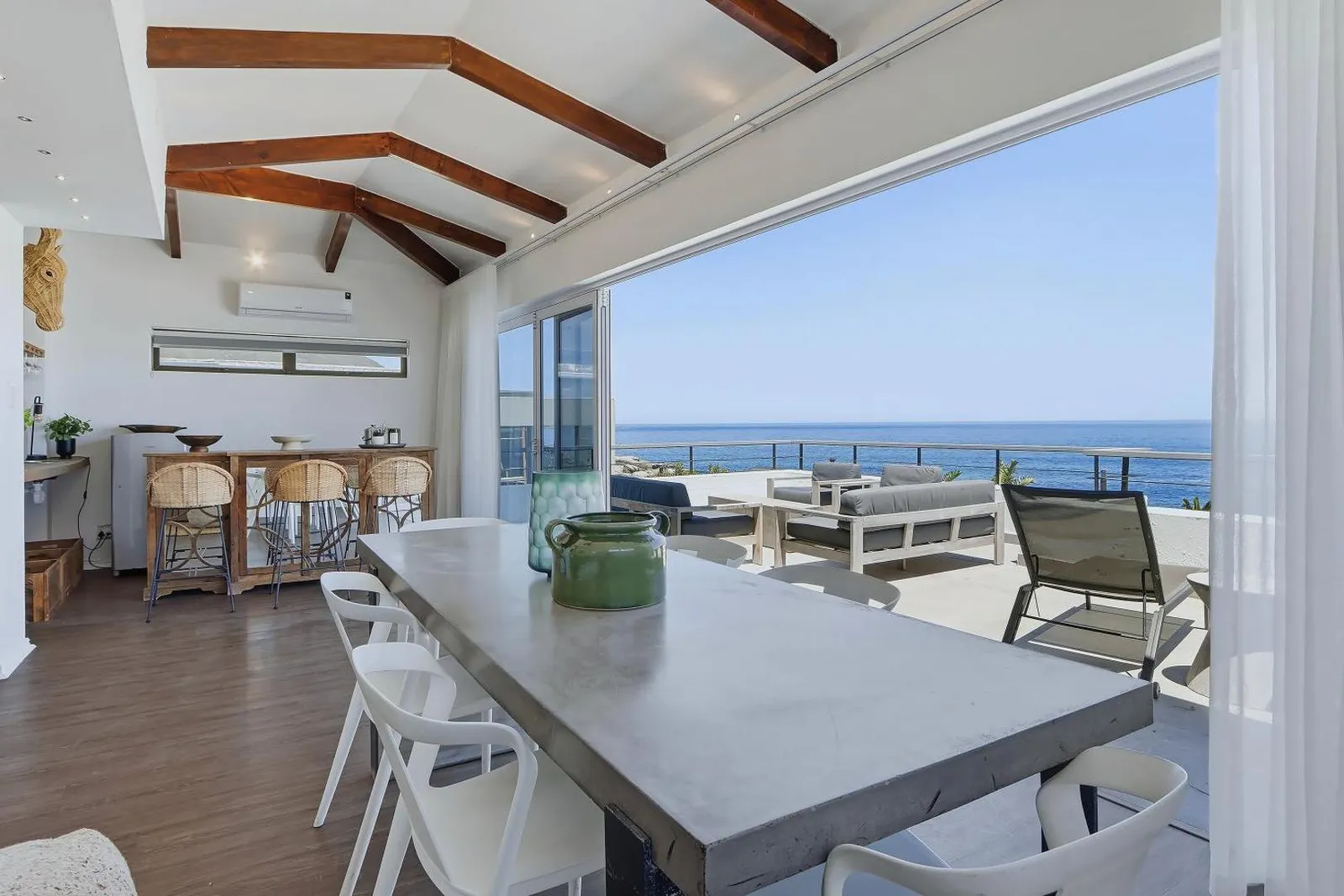 Dining table opening onto the sea-facing terrace