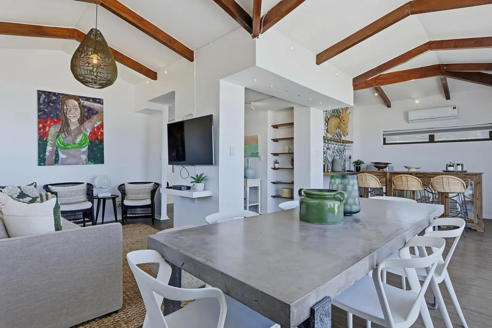 Open-plan living and dining under a beamed ceiling