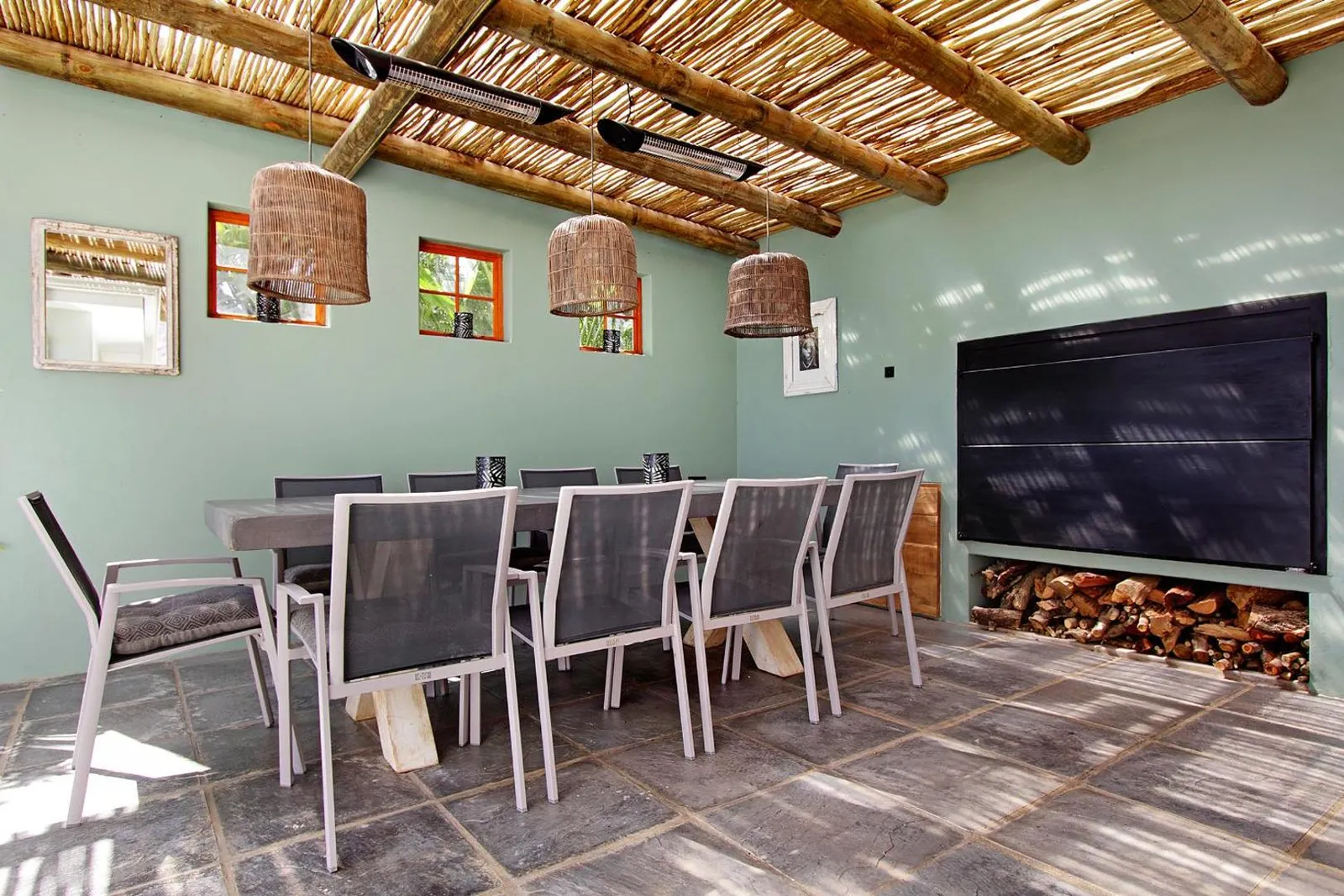 Thatched outdoor dining room with a long table