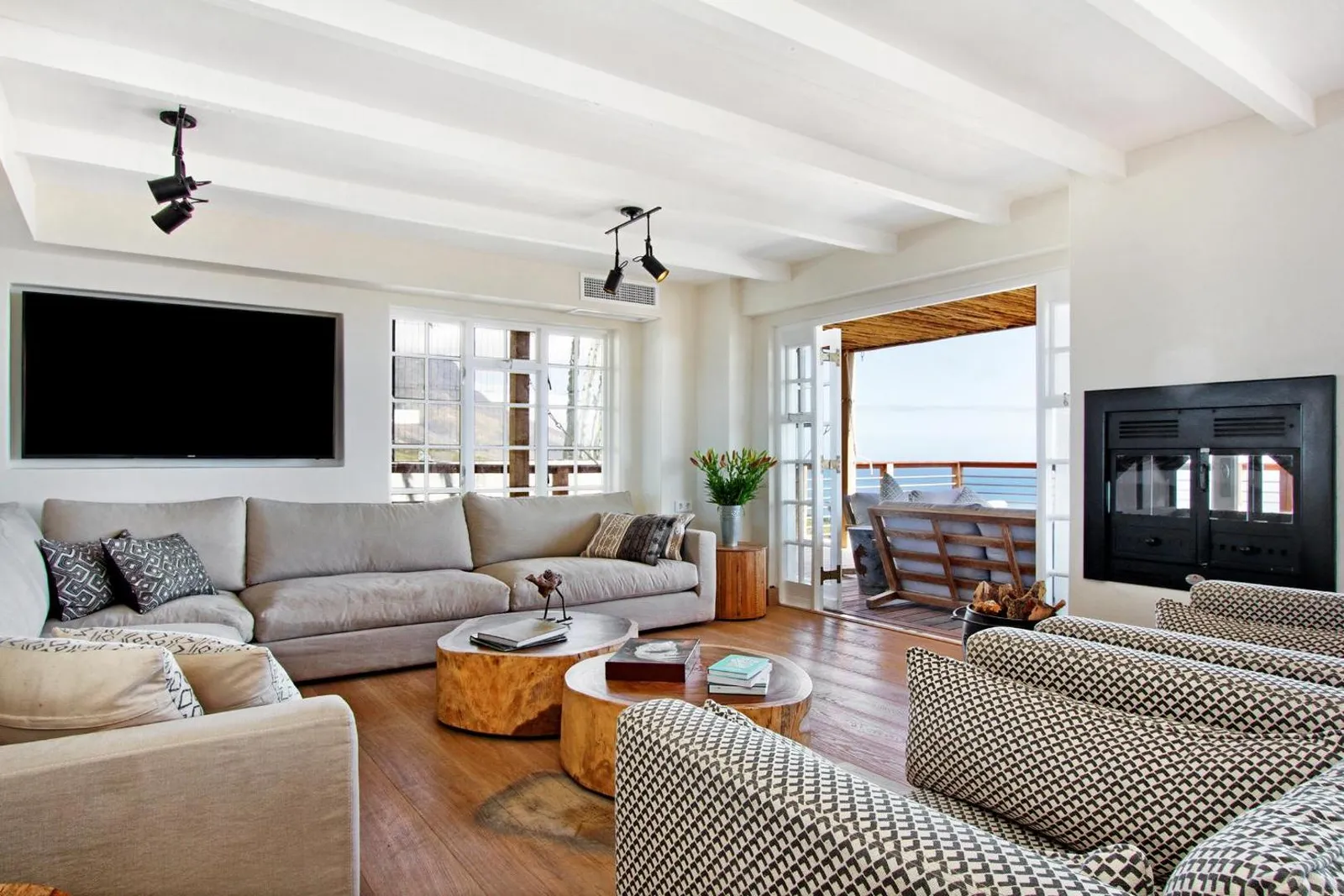 Living room with sea-facing doors and deep sofas
