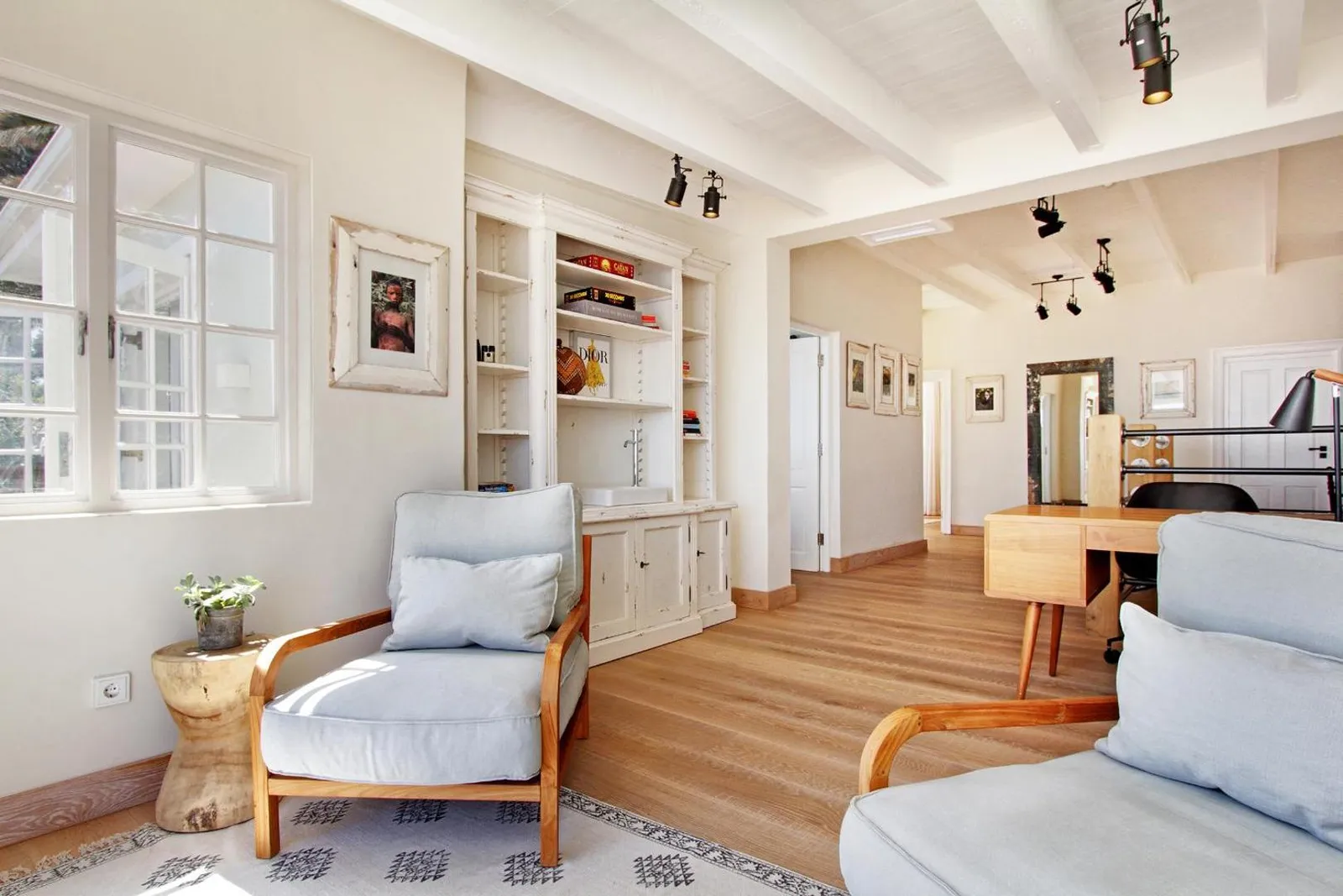 Sitting room with built-in shelves and a writing desk