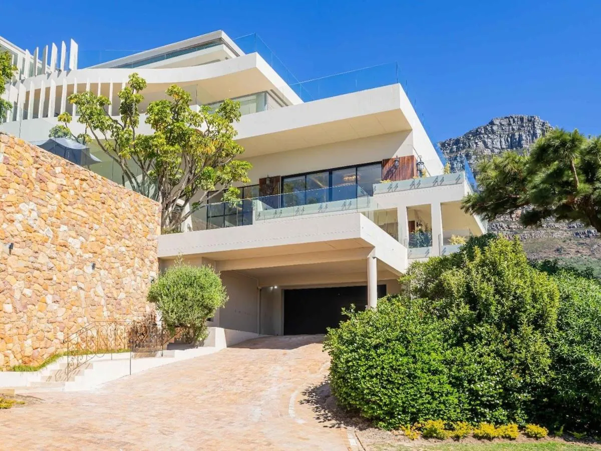 Villa exterior behind a stone wall with Lion's Head beyond