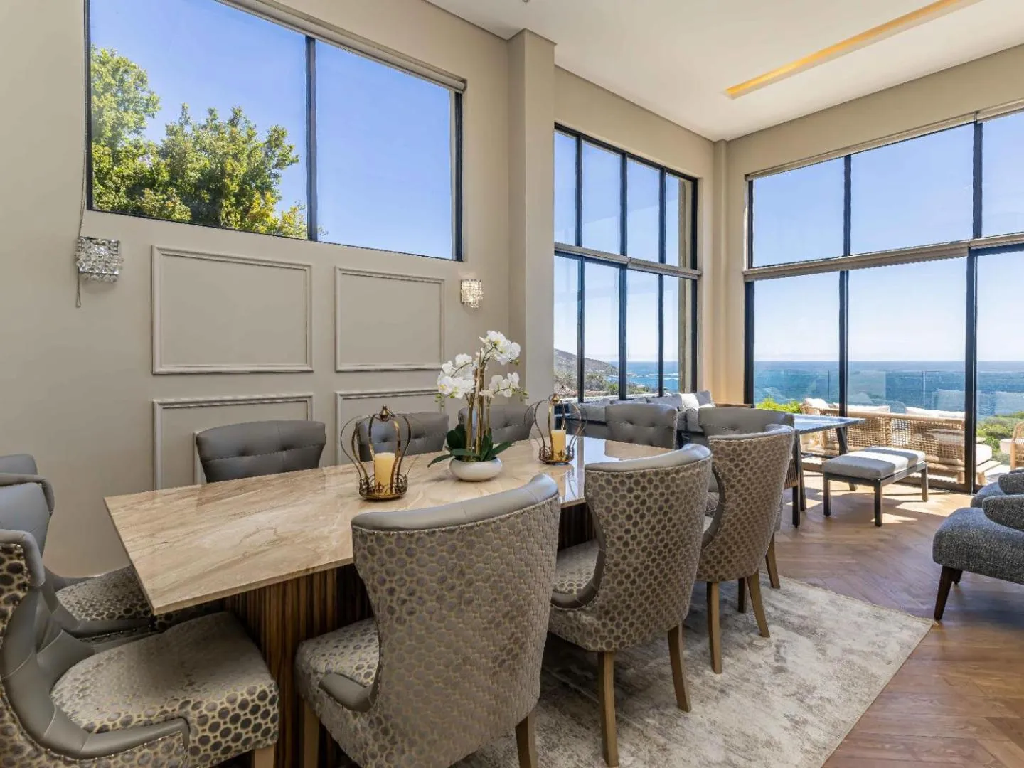 Dining area with floor-to-ceiling glass onto the sea