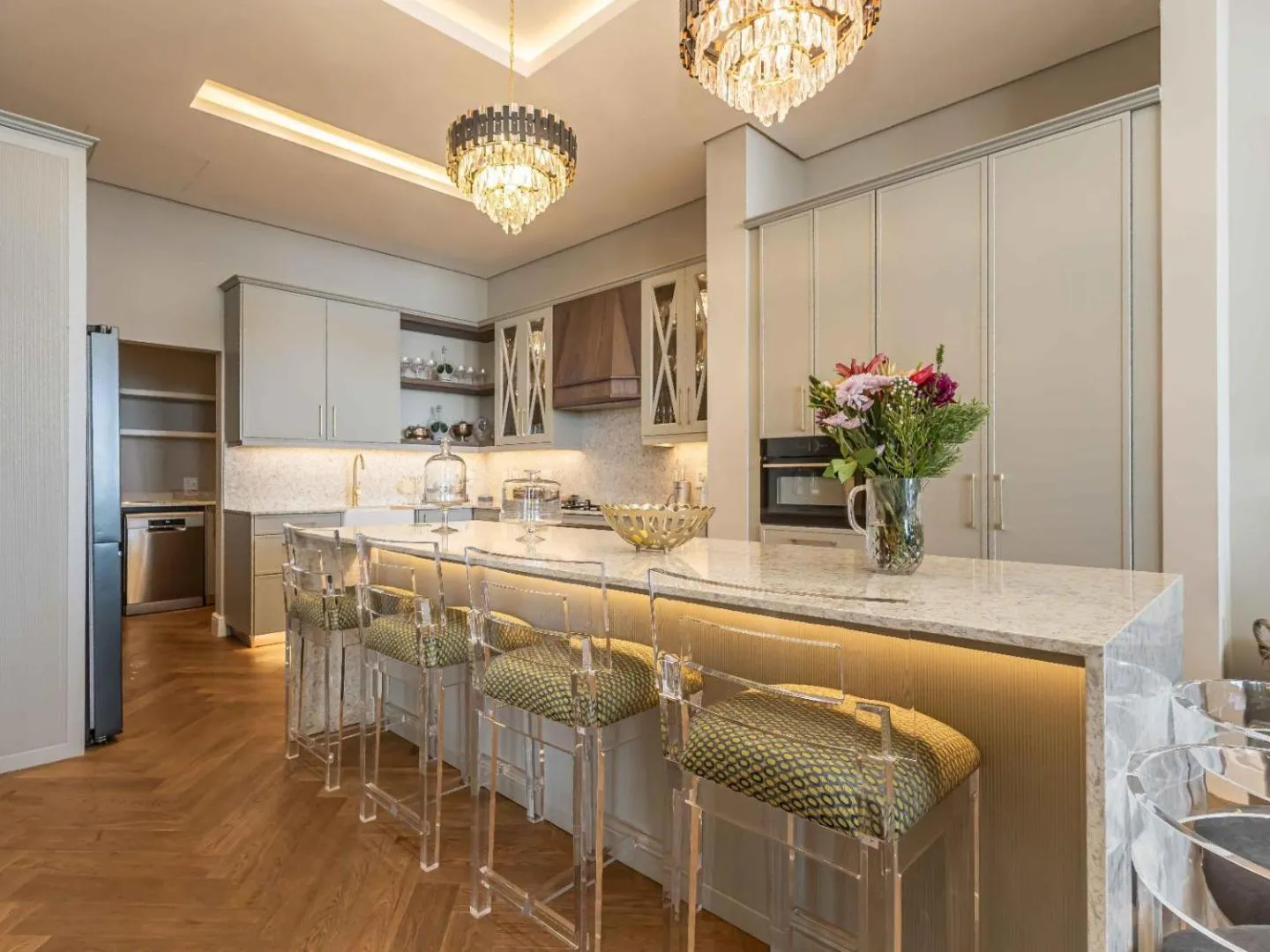 Kitchen island with bar stools and a wine fridge