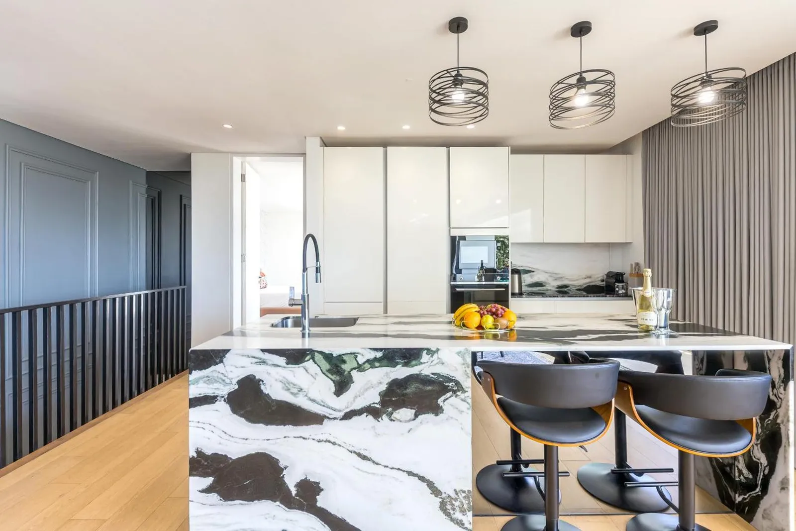 Kitchen with a breakfast bar and integrated appliances