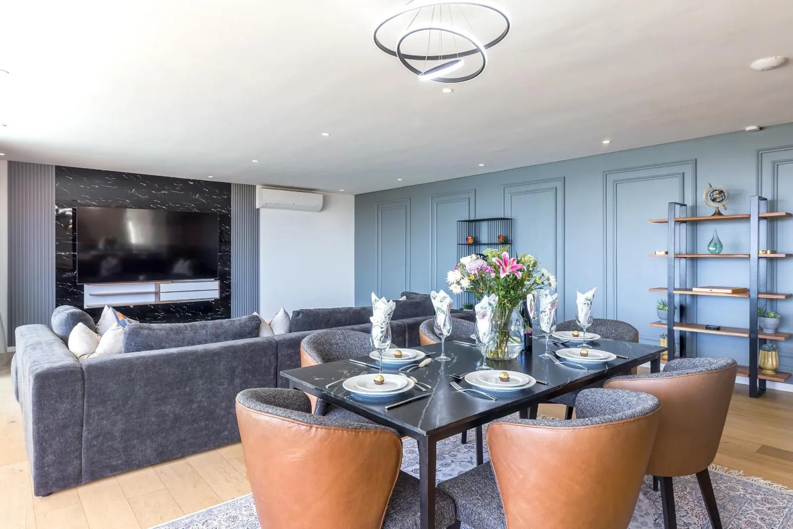Dining area beside the fireplace and panelled wall