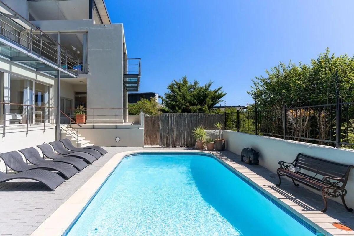 Pool and sun loungers alongside the villa