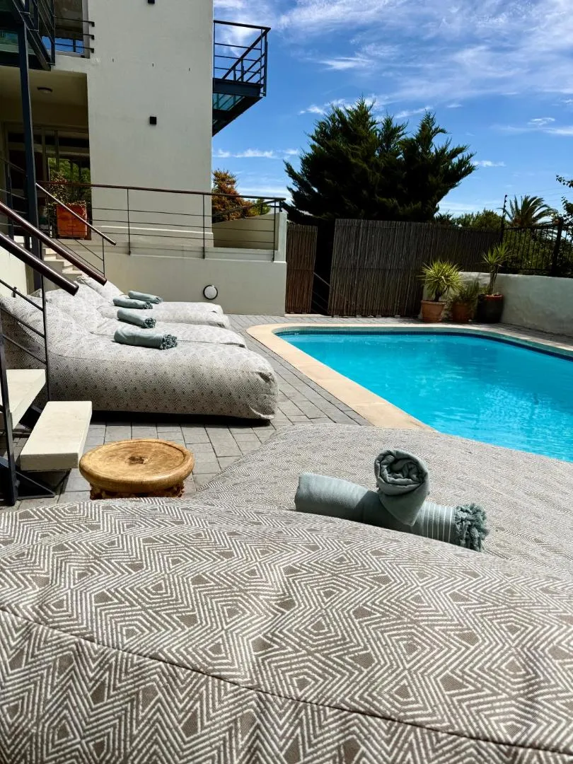 Poolside daybeds under the afternoon sun