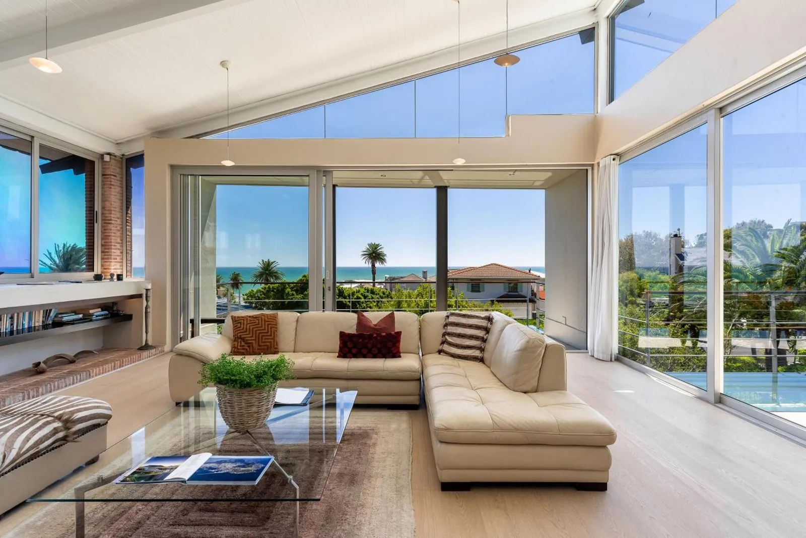 Open-plan living room with the sea through sliding doors