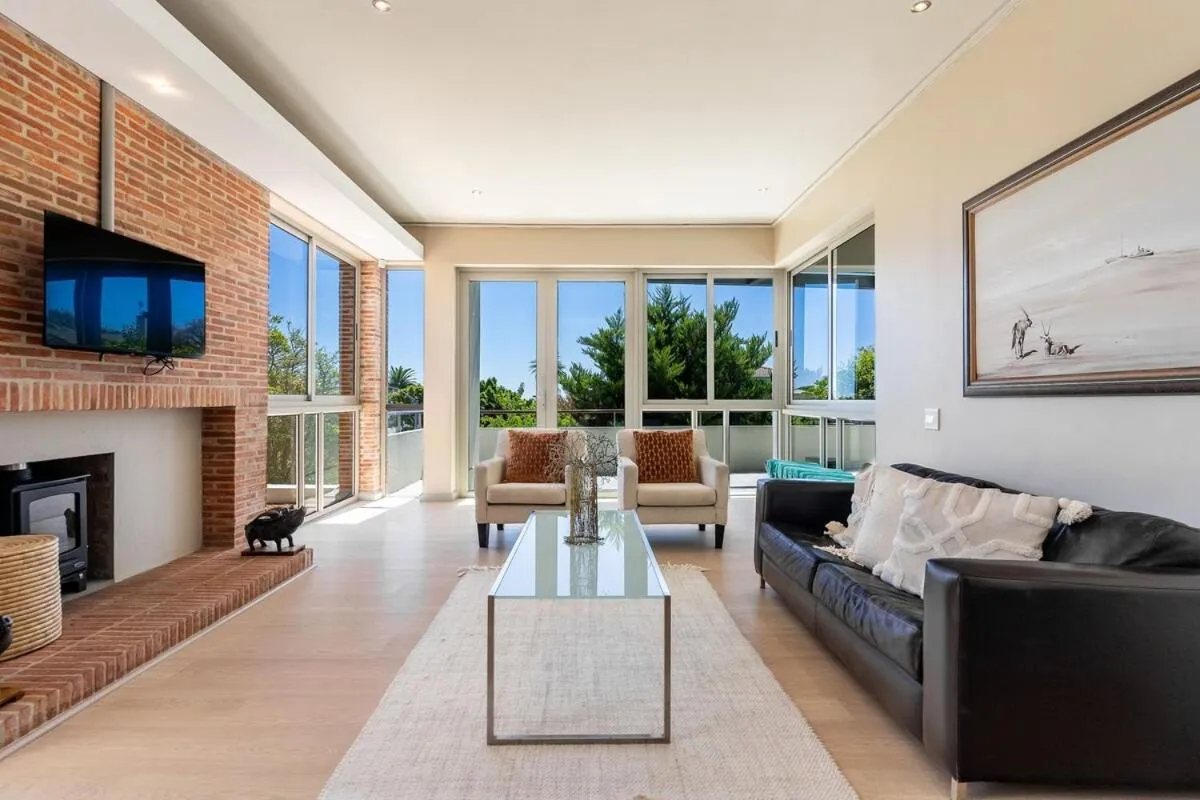 Living room with a fireplace and exposed brick wall