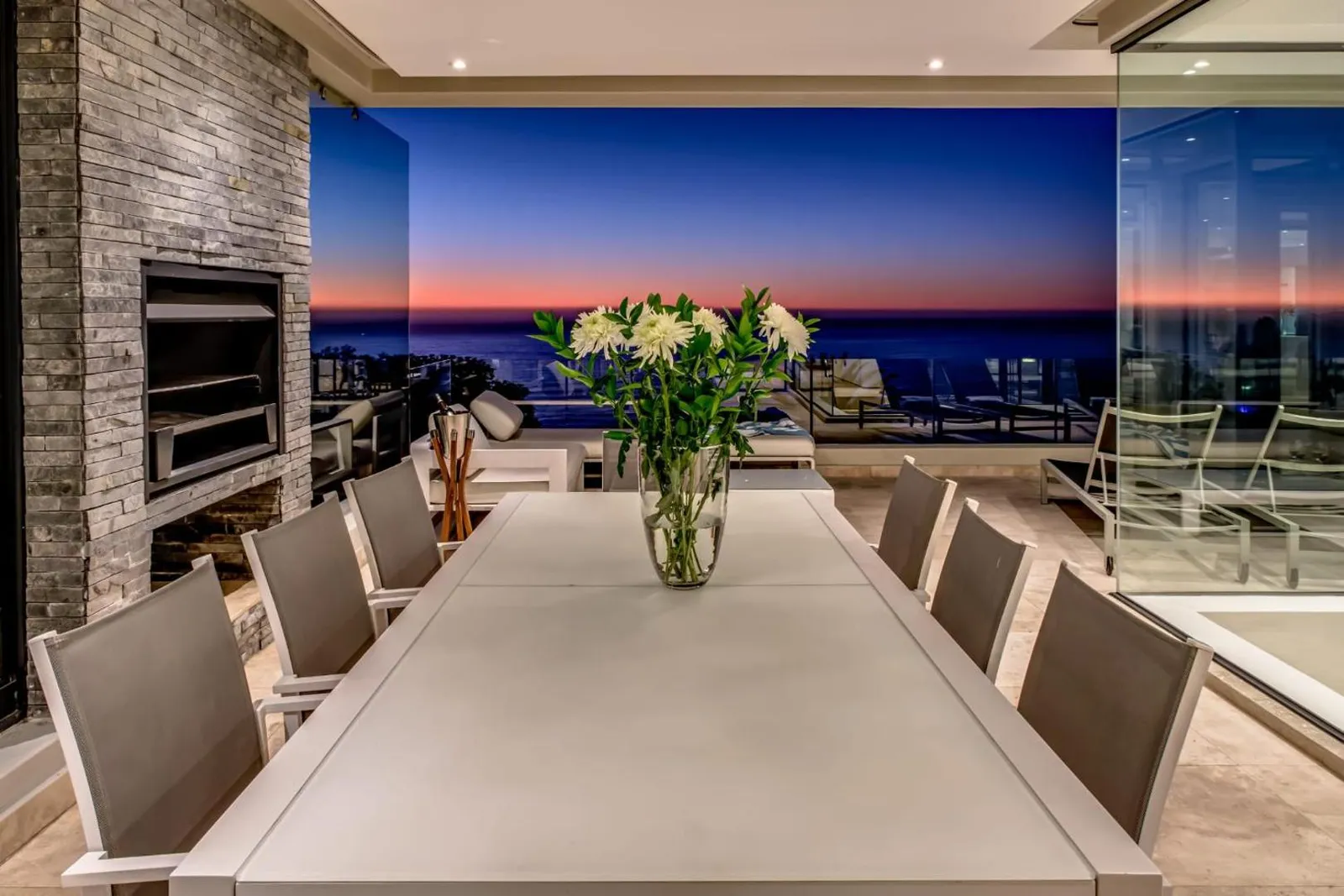Outdoor dining beside the fire pit at sunset