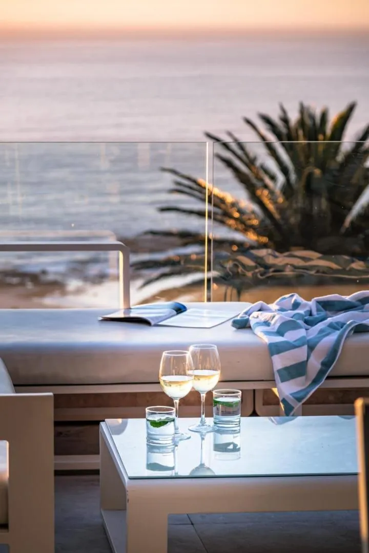 Poolside table set with wine at dusk