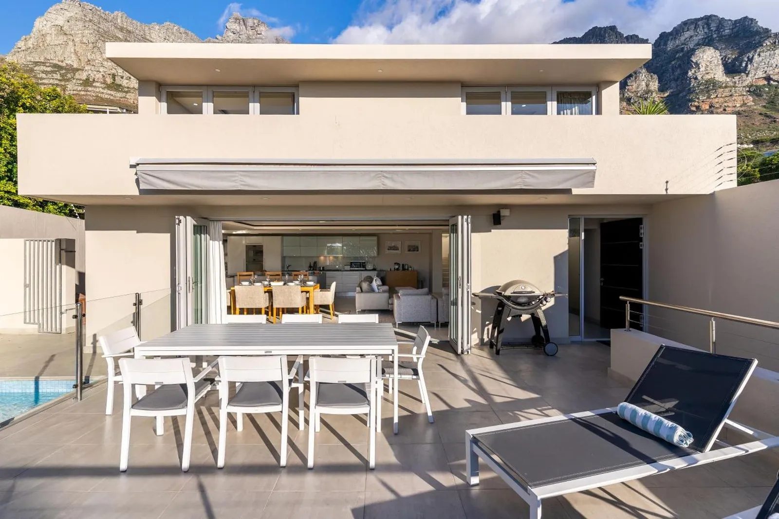 Covered terrace dining beside the pool