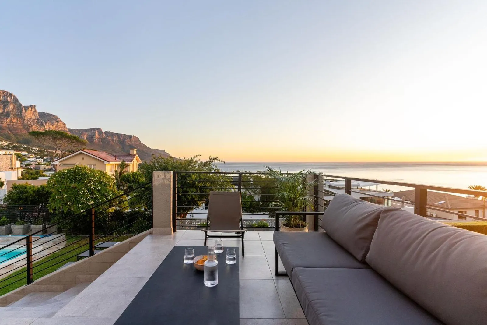 Terrace sofas facing the Twelve Apostles at dusk