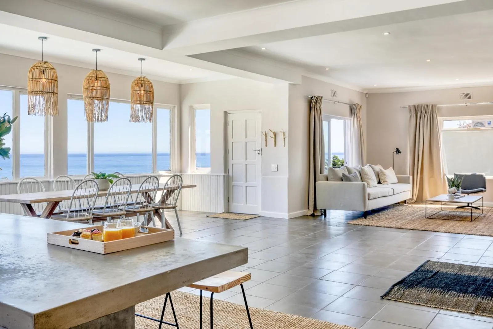 Open-plan living, dining and kitchen with ocean views