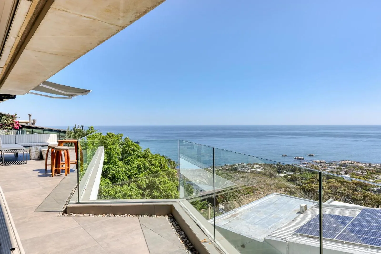 Terrace with a glass balustrade above the ocean
