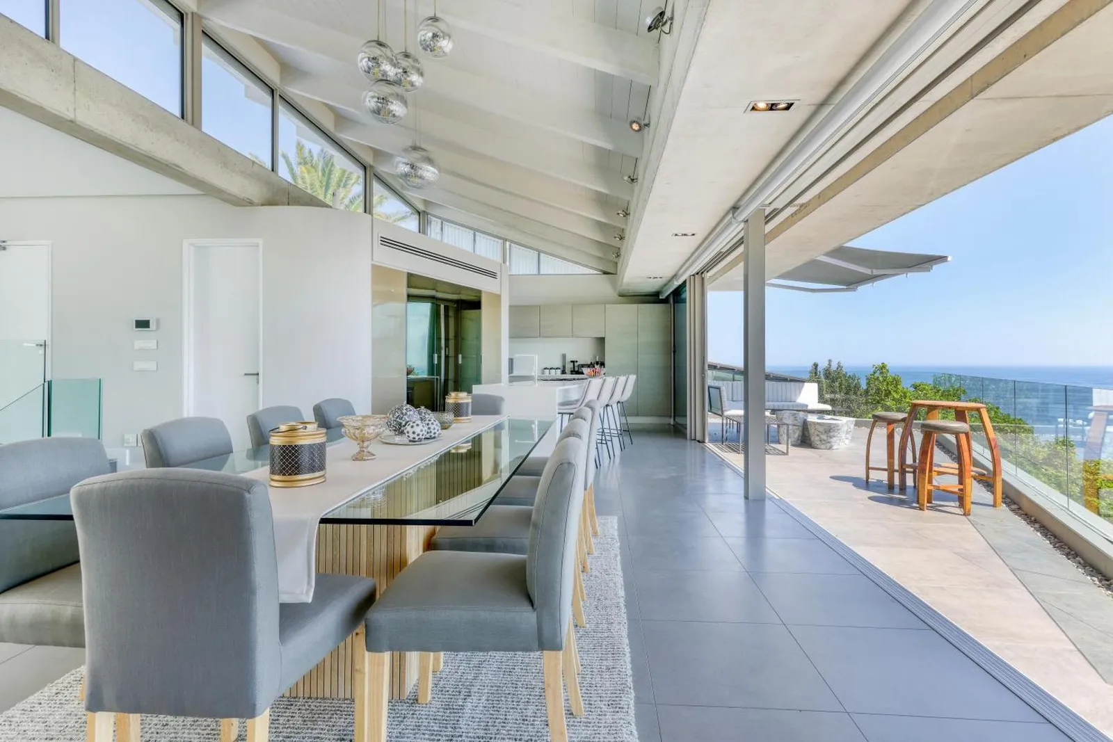 Long dining table opening onto the terrace