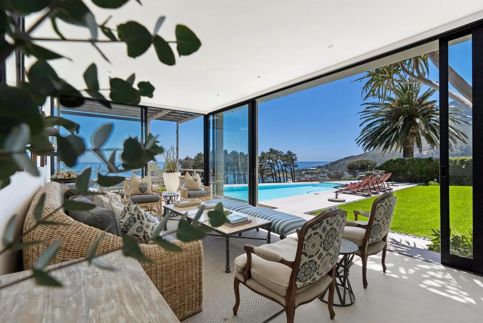 Lounge opening onto the pool terrace and the sea