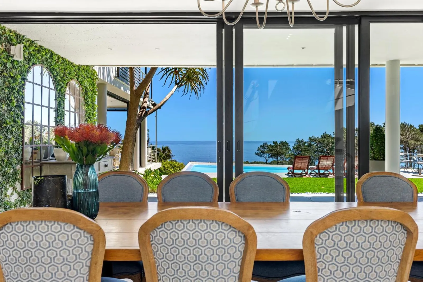 Dining table with ocean views through full-height glass