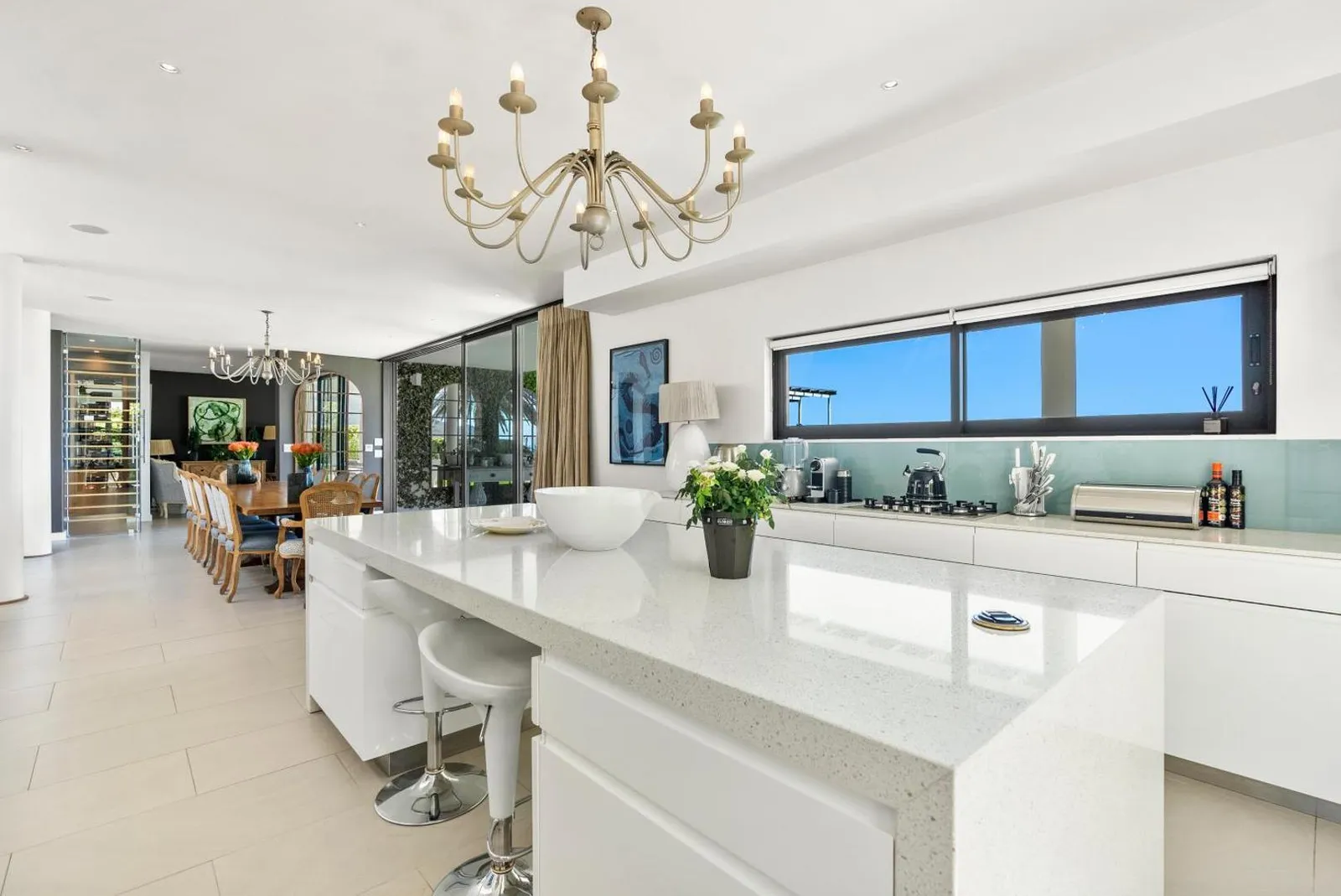 Open-plan kitchen island with dining beyond