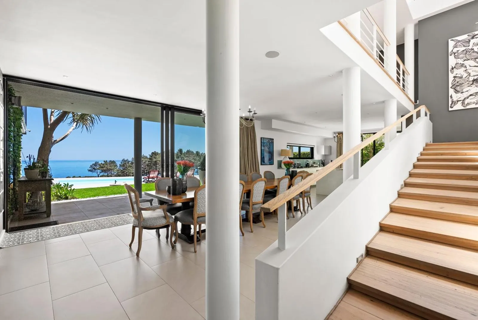 Dining area beside the staircase with sea views