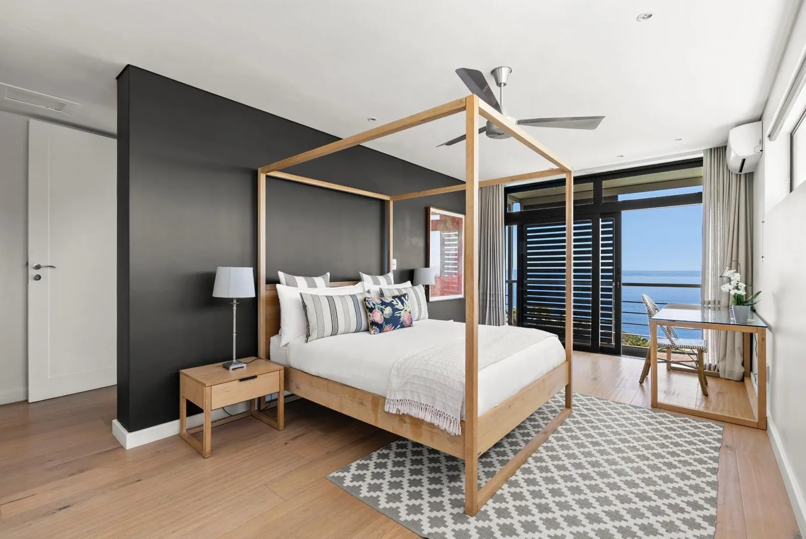 Main bedroom with a wall of glass onto the sea