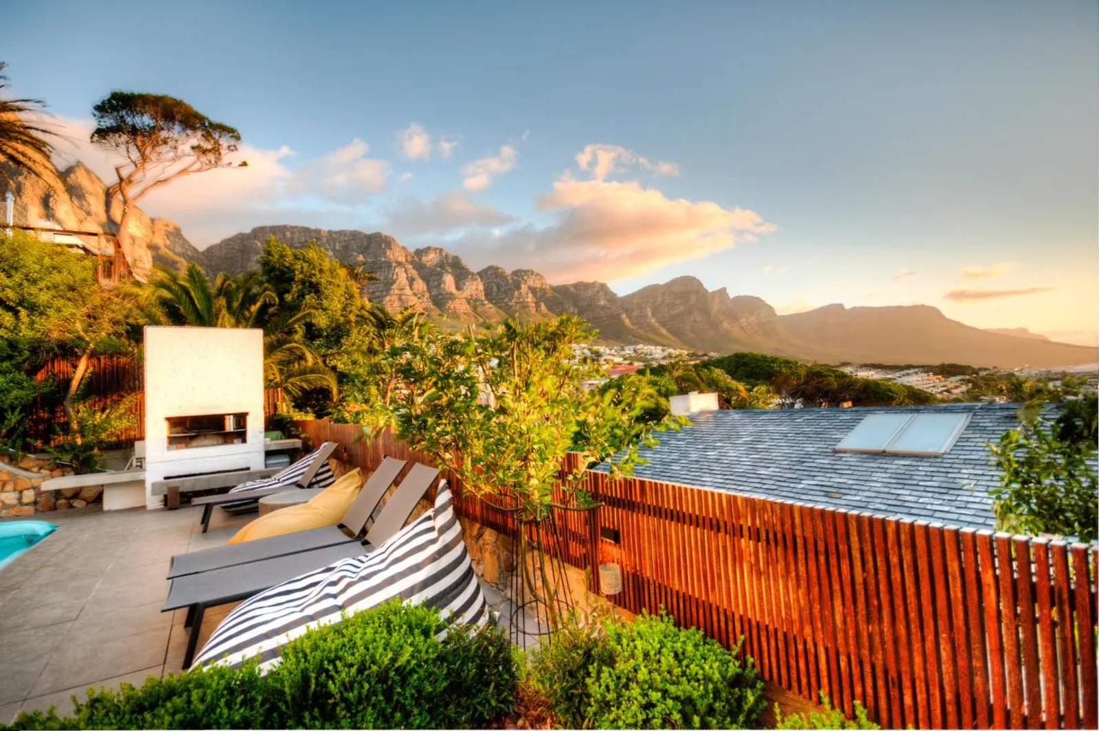 Sun loungers on the terrace at sunset below the mountains